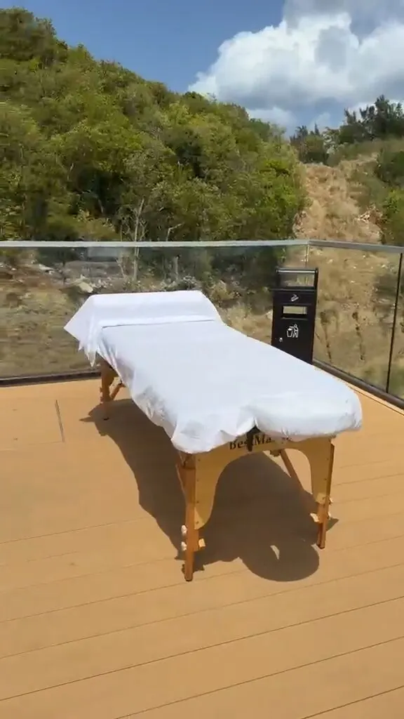 Massage table set up on a sunny rooftop deck for a quick relaxation session for cruise ship passengers